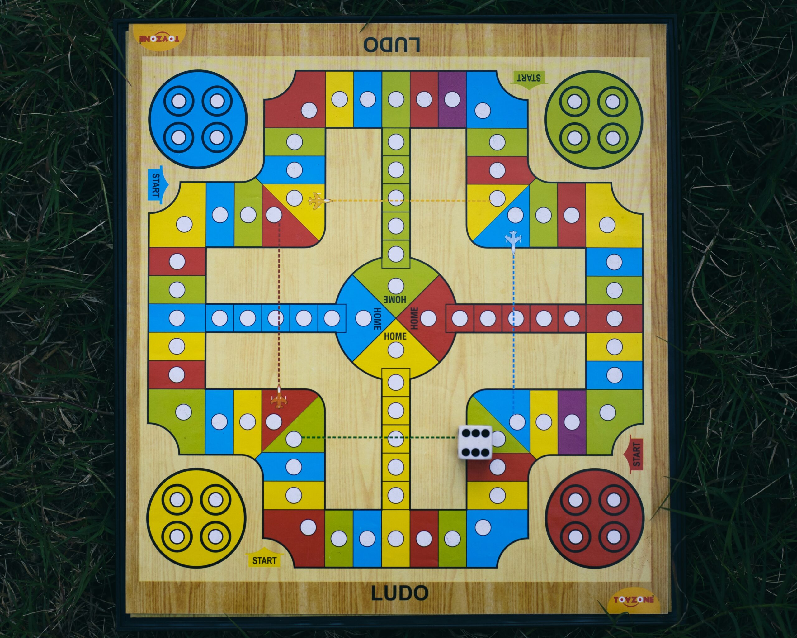 a wooden board game on the grass